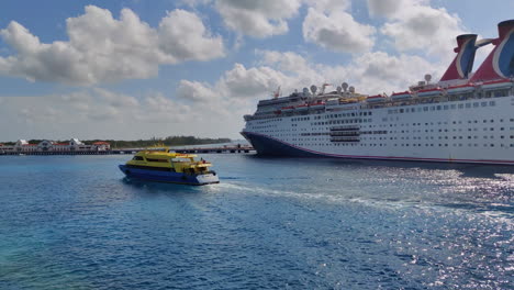 Experience-the-captivating-sight-of-two-Carnival-cruise-ships-docked-at-a-port-in-mexico,-while-a-tourist-boat-glides-past-A-vibrant-scene-showcasing-luxury,-adventure,-and-the-thrill-of-exploration
