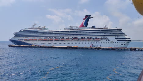 A-Carnival-Cruise-ship-slowly-moving-backward-and-approaching-pier-to-dock-and-ready-to-depart-tourists-to-the-island-|-Carnival-cruise-ship-arrived-at-port-and-preparing-to-dock-on-pier