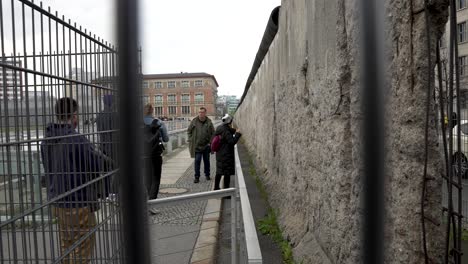Looking-Trough-Wire-Fence-Along-Section-Of-Original-Berlin-Wall-Located-At-Topography-of-Terror-In-Berlin
