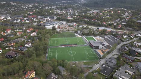 Sideways-Panning-shot-of-Football-pitches-in-Nesttun,-Norway