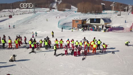 Aerial-Shot-of-People-Taking-Ski-Lessons-on-Ski-Hill-in-Northern-China