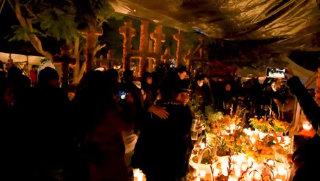 People-celebrating-the-day-of-the-dead-in-a-Mexican-cemetery-in-Tzintzuntzan,-Michoacán,-Mexico,-one-of-the-most-representative-to-celebrate-the-day-of-the-dead