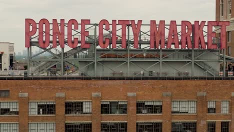 Aerial-shot-of-the-large-sign-on-top-of-Ponce-City-Market-in-Atlanta,-Ga