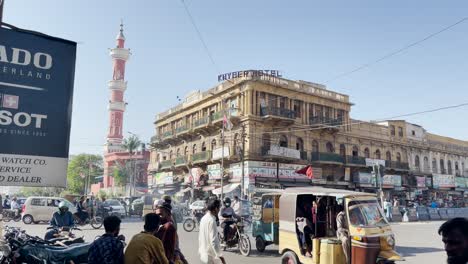 Khyber-Hotel-In-Saddar-In-Karachi-With-Daily-Traffic-Going-Past-On-Sunny-Day-With-Blue-Skies