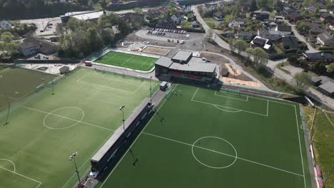 Panning-Aerial-View-of-Footballers-Training-at-a-Pitch-in-Bergen,-Norway