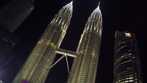 Quick-establishing-tilt-up-over-beautiful-Petronas-Twin-Towers-with-water-show-at-night