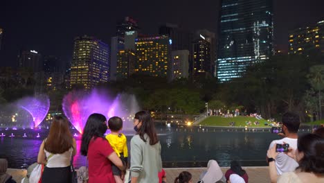 People-watching-famous-water-show-at-Petronas-Towers-in-Kuala-Lumpur,-Malaysia