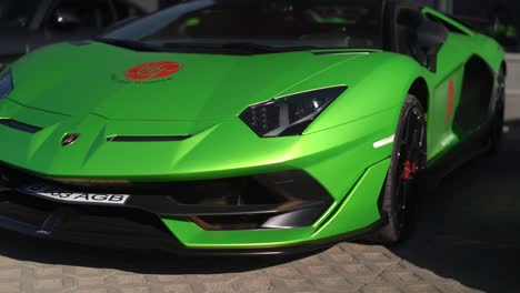 Frontal-shot-of-a-green-Lamborghini-on-a-sunny-day