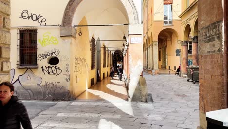 People-walking-through-Castiglione-street-in-downtown-Bologna