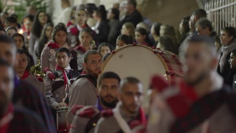Marching-band-drummer-beats-large-drum-in-Easter-parade,-Nazareth,-ISR