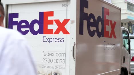Chinese-pedestrians-walk-past-an-American-delivery-services-and-logistics-company-FedEx-truck-is-seen-stationed-in-the-street-of-Hong-Kong