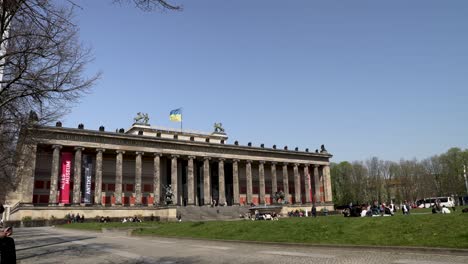 The-Altes-Museum-Located-Beside-The-Pleasure-Garden-In-Berlin-On-Nice-Sunny-Clear-Day-With-Flag-Of-Ukraine-Fluttering-In-Wind