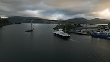 Fjord1-'Hornelen'-Ferry-Driving-under-a-Bridge-in-Måløy,-Norway