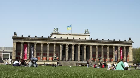 The-Altes-Museum-Located-Beside-The-Pleasure-Garden-In-Berlin-On-Nice-Sunny-Clear-Day-With-Flag-Of-Ukraine-Fluttering-In-Wind