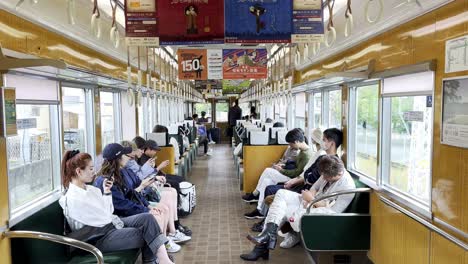 Commuters-sitting-inside-Kyoto-subway-train-during-the-day