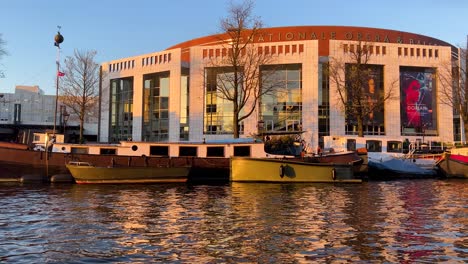 View-through-the-window-of-a-gliding-boat-on-Dutch-National-Opera-and-Ballet-Theatre-at-sunset