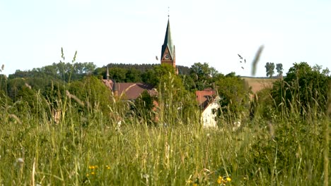 Sanctuary-of-Our-Lady-of-Gietrzwałd,-tower-seen-from-above-the-grass