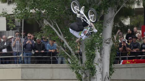 BMX-rider-performing-a-front-flip-with-his-bike-over-the-ramp