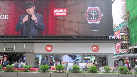 A-Swiss-manufacturer-of-wristwatches-commercial-banner-from-Tudor-brand-is-seen-above-the-Chinese-multinational-technology-and-electronics-brand-Xiaomi-flagship-store-and-logo-in-Hong-Kong