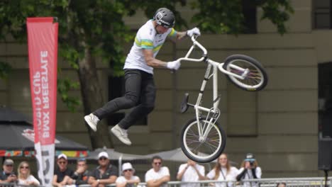 BMX-rider-jumps-over-a-high-ramp-and-performs-a-360-flip-tail