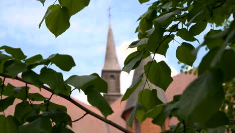 The-tower-of-the-Sanctuary-of-Our-Lady-of-Gietrzwałd-seen-through-the-leaves-of-trees