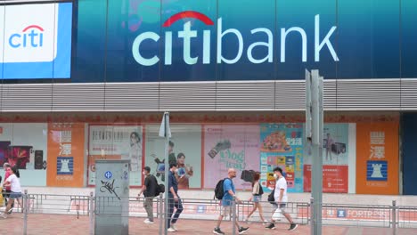 Pedestrians-walk-past-the-American-multinational-investment-bank,-Citibank-or-Citi,-branch-in-Hong-Kong