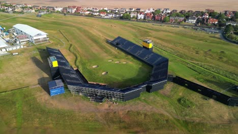 Preparations-for-The-2023-Open-at-Royal-Liverpool-Golf-Club,-Wirral,-UK---Aerial-drone-18th-green-focus-and-clockwise-slow-pan