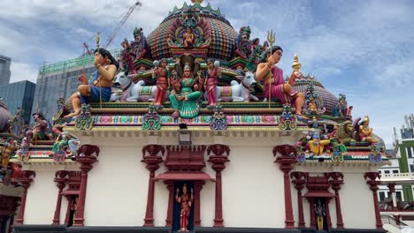Tilt-up-view-of-the-colourful-and-detailed-sculptures-of-various-Hindu-deities-and-mythological-figures-at-Sri-Mariamman-Temple-in-the-heart-of-Chinatown,-Singapore