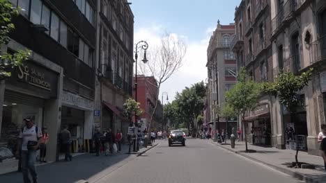 Driving-on-Calle-Tacuba,-one-of-the-oldest-streets-in-Mexico-City