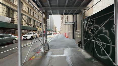 POV-Walking-Along-Under-Scaffolding-On-Sidewalk-In-New-York-On-Overcast-Day
