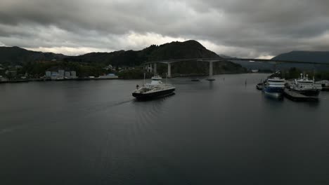 Fjord1-'Hornelen'-Ferry-approaching-a-Bridge-in-Måløy,-Norway