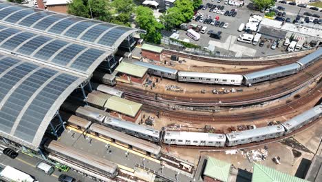 Aerial-establishing-shot-of-two-New-York-City-subway-trains-entering-station-in-NYC