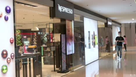 Chinese-customers-walk-past-the-Swiss-high-end-and-world-leader-in-coffee-capsules-brand-store-Nespresso-in-Hong-Kong