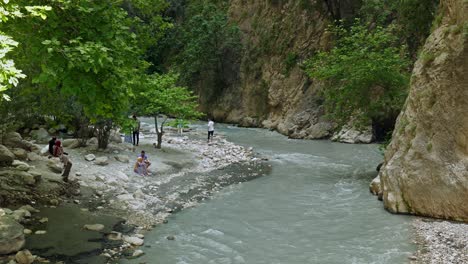 Visitors-to-Saklikent-gorge-explore-steep-canyon-with-rushing-rapid-waters