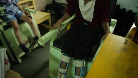 There-is-a-very-young-child-who-cannot-walk-on-his-own-and-with-bandaged-legs-and-sitting-on-a-wheelchair,-he-is-doing-well-in-the-classroom-and-is-very-happy,-Right-to-Education