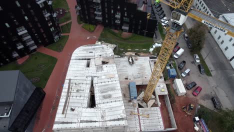 drone-shot-of-new-Riia-kvartal-district-building-processes,-building-of-the-final-house-in-project-next-to-main-Riia-street-in-Tartu