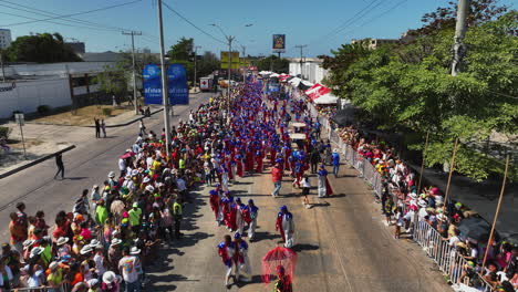 Battle-of-flowers-parade-full-of-vibrant-costumes-in-Barranquilla,-Colombia---Aerial-view