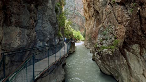 Path-safety-walkway-fixed-to-cliff-rocks-in-narrow-river-ravine-gorge