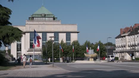 Public-Library-De-Tours-with-flags-swinging-on-light-breeze-on-square-with-monument-Résistance-et-Déportation