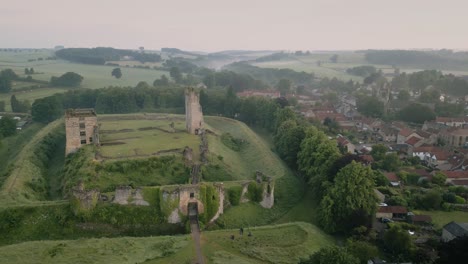 Low-level-aerial-4K-from-drone-in-an-arc-southern-boundary-of-Helmsley-Castle-ruins-in-North-Yorkshire,-England