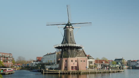 Dutch-Heritage:-Historic-Windmill-by-the-Water-in-Haarlem,-Netherlands-on-a-Sunny-Day