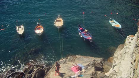 Italian-Fishing-Boats-Docked-on-Water-on-Hot-Sunny-Summer-Day-in-Riomaggiore-Italy-in-Beautiful-Cinque-Terre