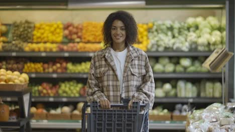 Beautiful-black-woman-with-shopping-cart-at-the-supermarket