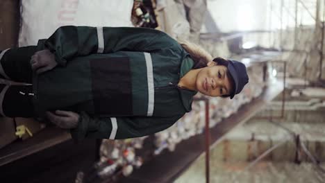 portrait-of-a-young-African-American-woman-checks-a-conveyor-belt-at-a-recycling-plant.-Pollution-control