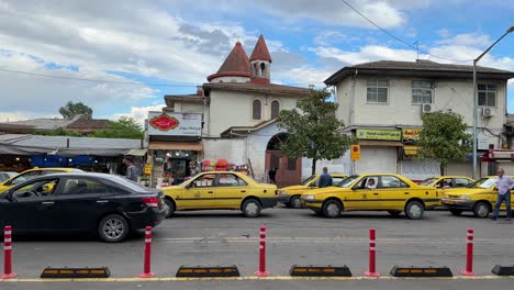 Old-city-of-Rasht-in-a-scenic-beautiful-weather-blue-sky-with-white-clouds-in-a-day-time-travel-in-middle-east-Asia-Taxi-cab-waiting-in-street-red-roof-local-ancient-church-Christian-religious-place