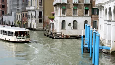 Vaporetto-Waterbus-Going-Past-Gondola-On-Grand-Canal-In-Venice