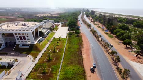 Cinematic-aerial-view-of-modern-Gambia-National-assembly-building-in-Banjul-city,-West-Africa