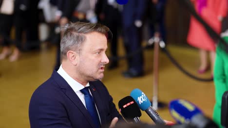 Prime-Minister-of-Luxembourg-Xavier-Bettel-giving-an-interview-during-the-European-Council-summit-in-Brussels,-Belgium---Slow-motion-shot
