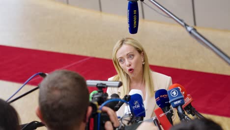 Prime-Minister-of-Italy-Giorgia-Meloni-giving-an-interview-during-the-European-Council-summit-in-Brussels,-Belgium---Medium-close-shot