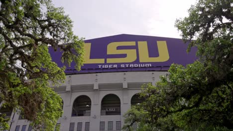 Louisiana-State-University-Tiger-Stadium-with-gimbal-video-walking-forward-through-trees-in-slow-motion-close-up